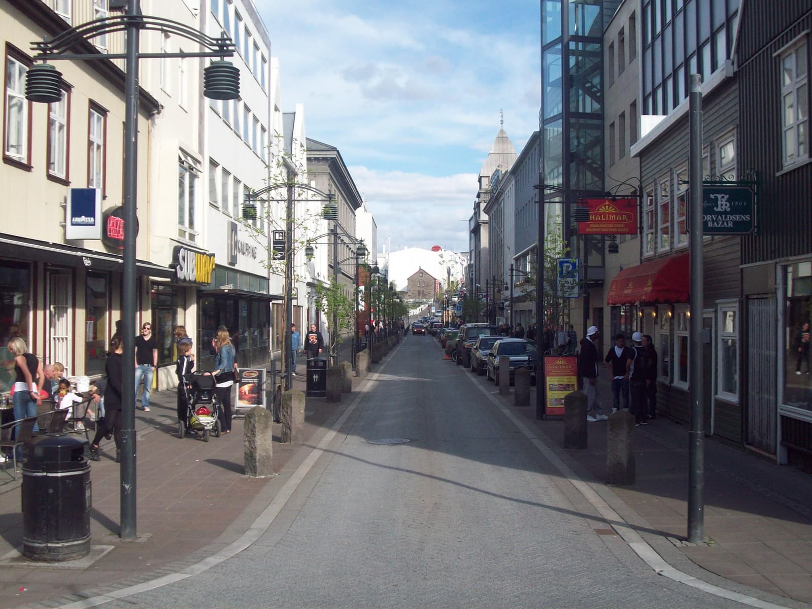 Austurstræti street in downtown Reykjavík with shops, pedestrians, and old-center buildings.