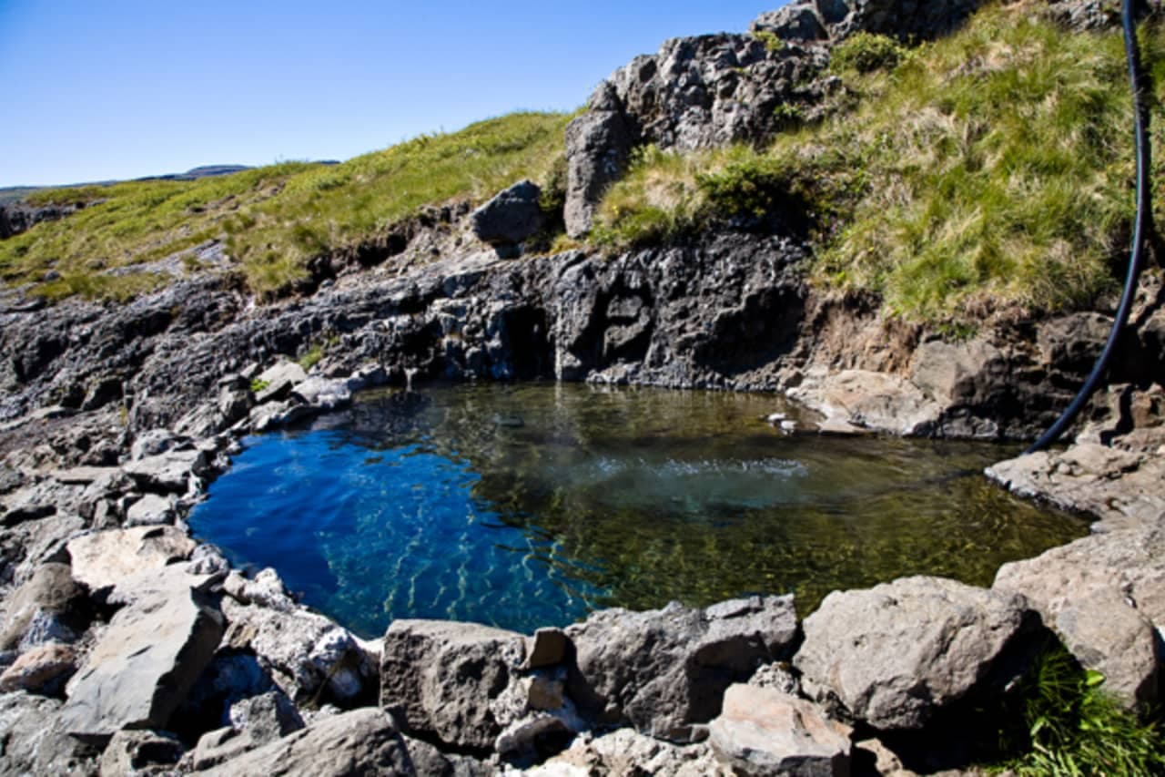Hellulaug hot pool near Flókalundur set into the rocks above the shore in Vatnsfjörður.
