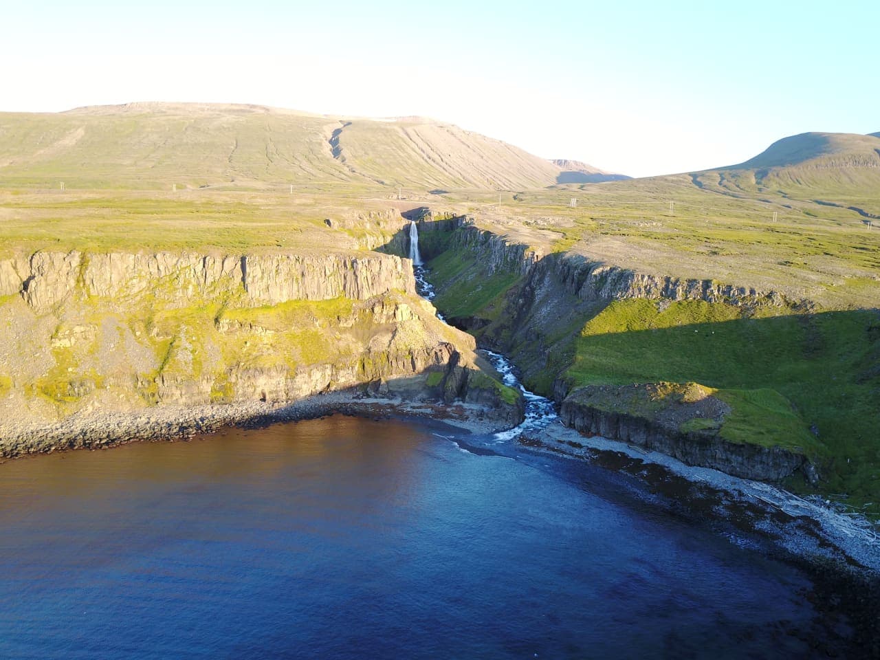 A coastal view of Gljúfursárfoss where the river cuts through cliffs before reaching Vopnafjörður.