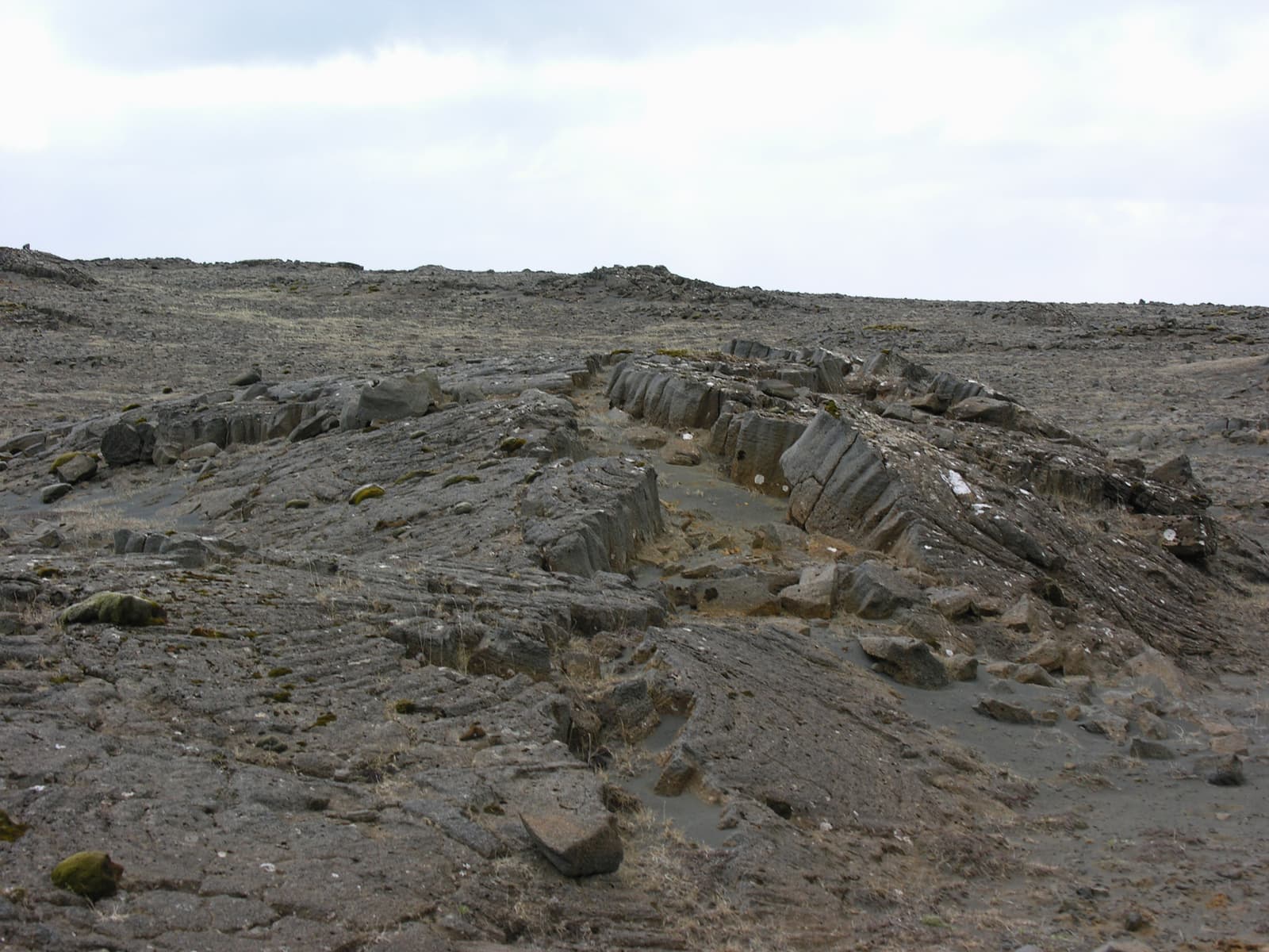 Grey volcanic rock formations in the Hafnir area of the Reykjanes Peninsula.