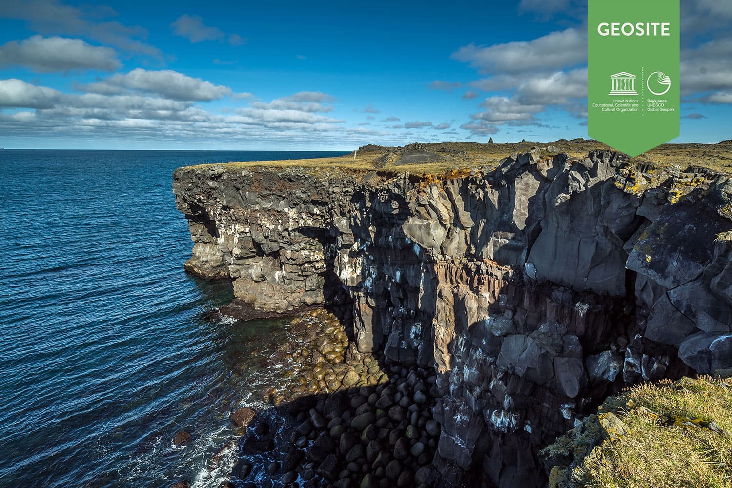Hafnarberg Sea Cliffs with layered lava rock, Atlantic water, and the exposed Reykjanes coastline.