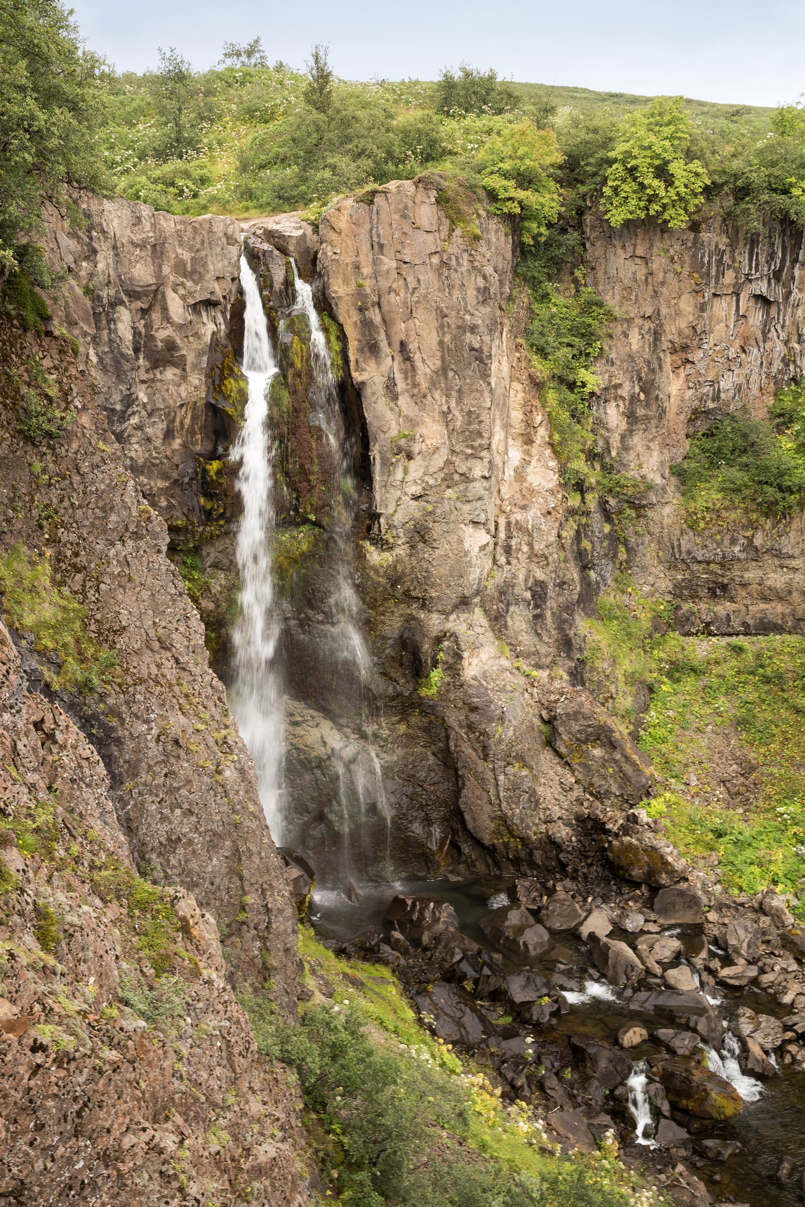 Hundafoss seen through the steep green-sided gorge in Skaftafell.