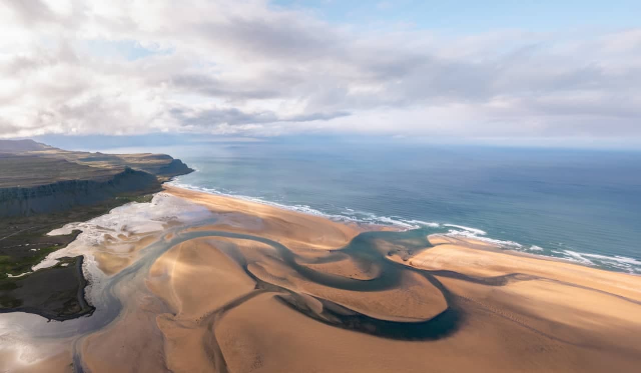 Aerial view of Rauðasandur's broad sand bars and long shoreline in the southern Westfjords.
