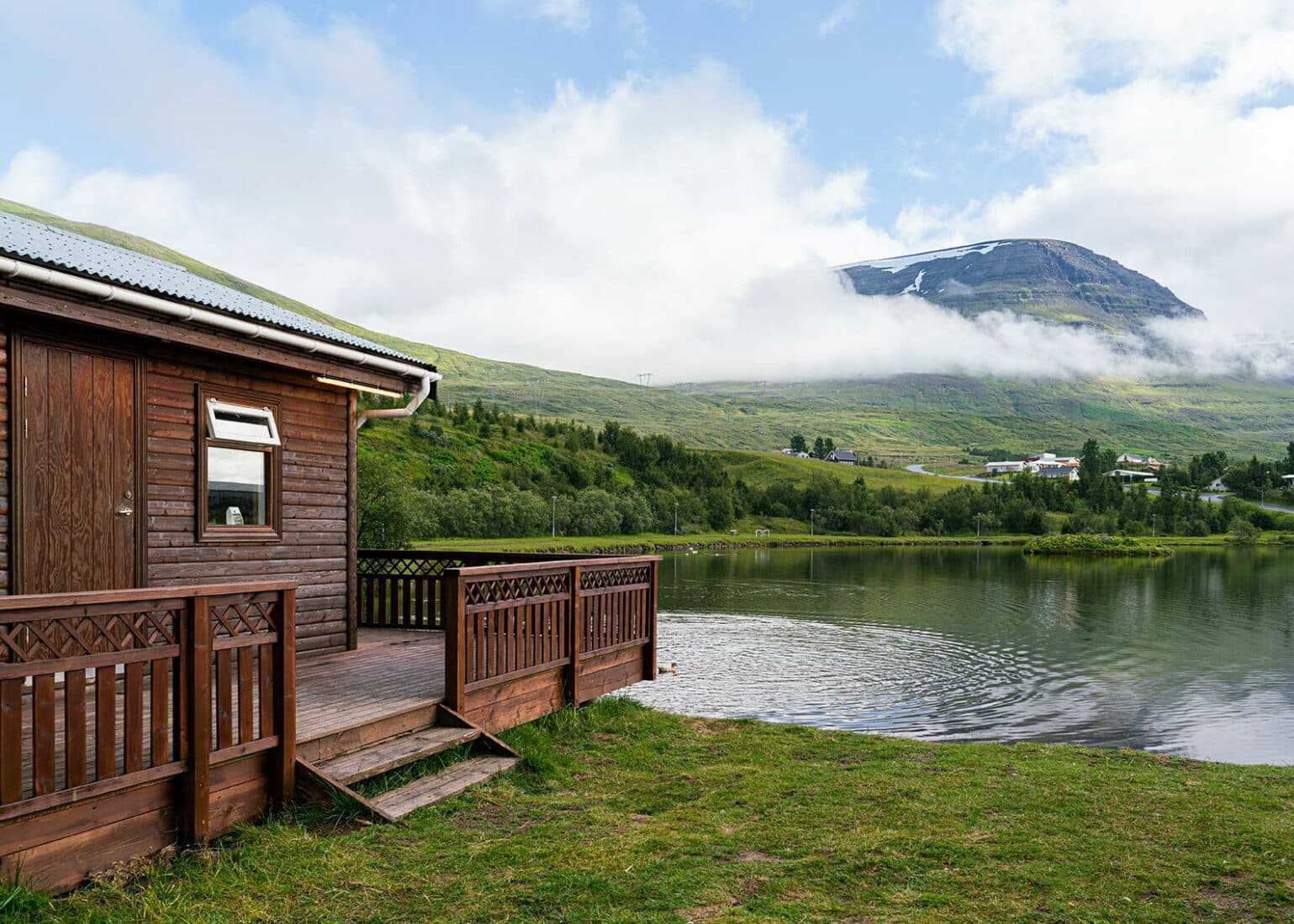 Reyðarfjörður pond and houses with Eastfjords mountains rising behind town.