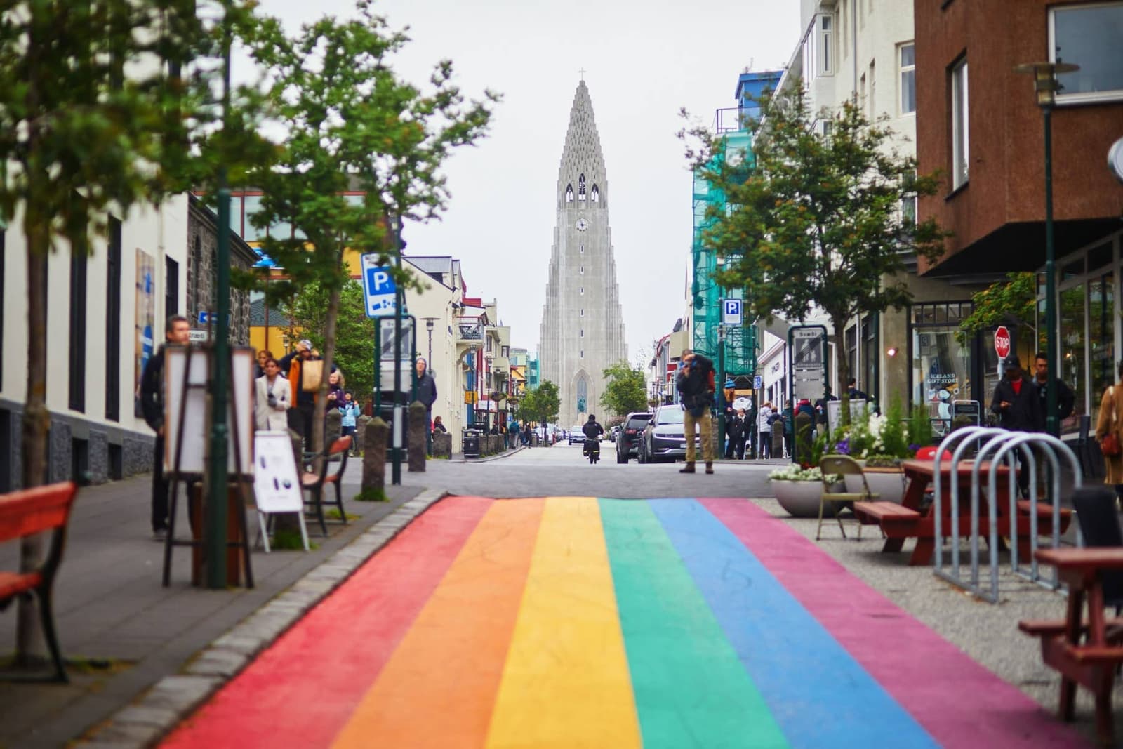 Rainbow-painted Skólavörðustígur leading uphill toward Hallgrímskirkja in Reykjavík.
