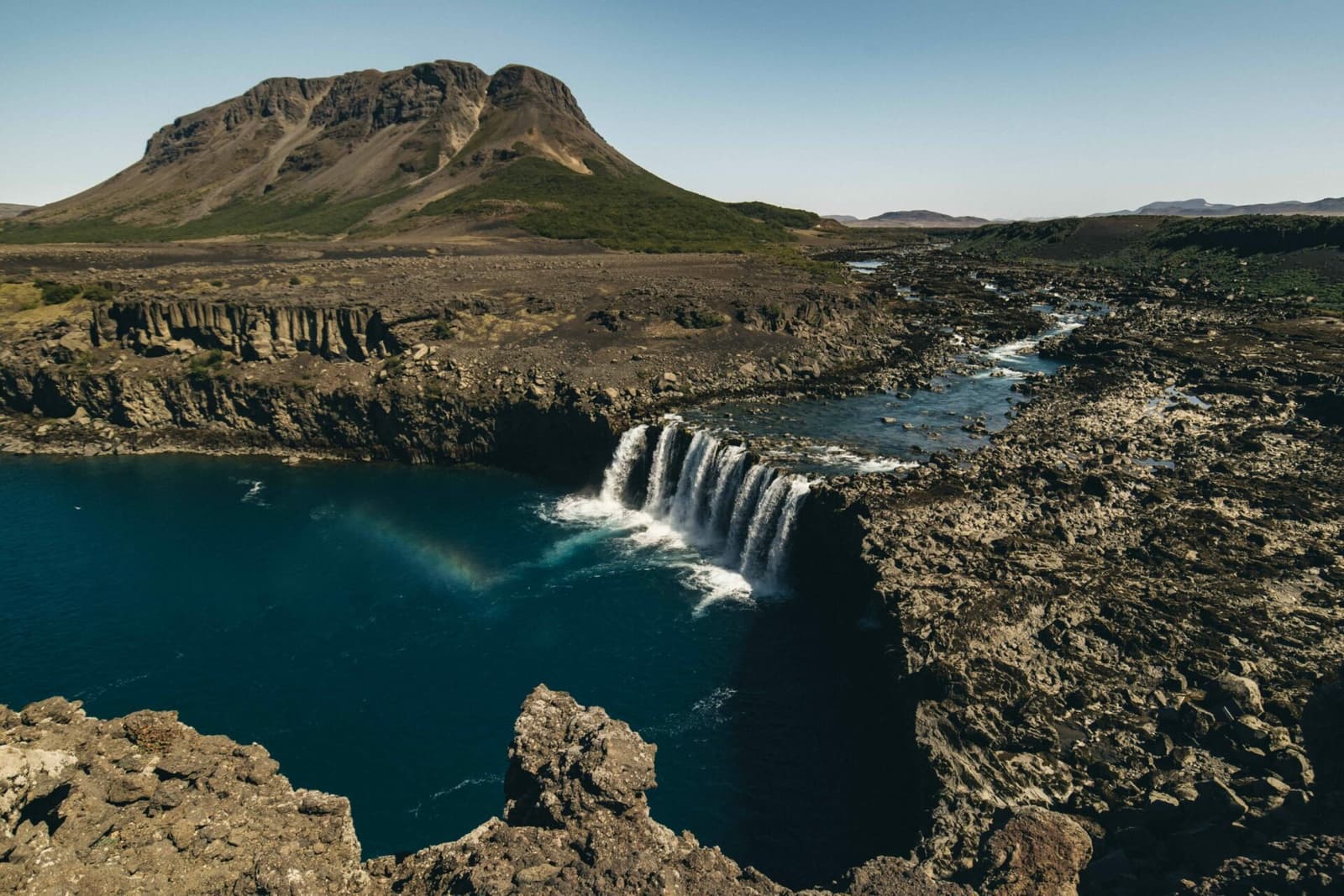 Þjófafoss waterfall on Þjórsá with Búrfell mountain and winter snow in South Iceland.