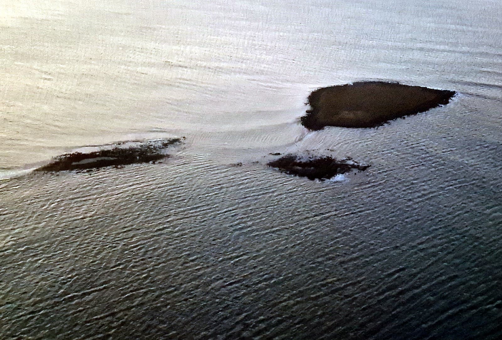 Akurey island surrounded by shallow water in Kollafjörður near Reykjavík