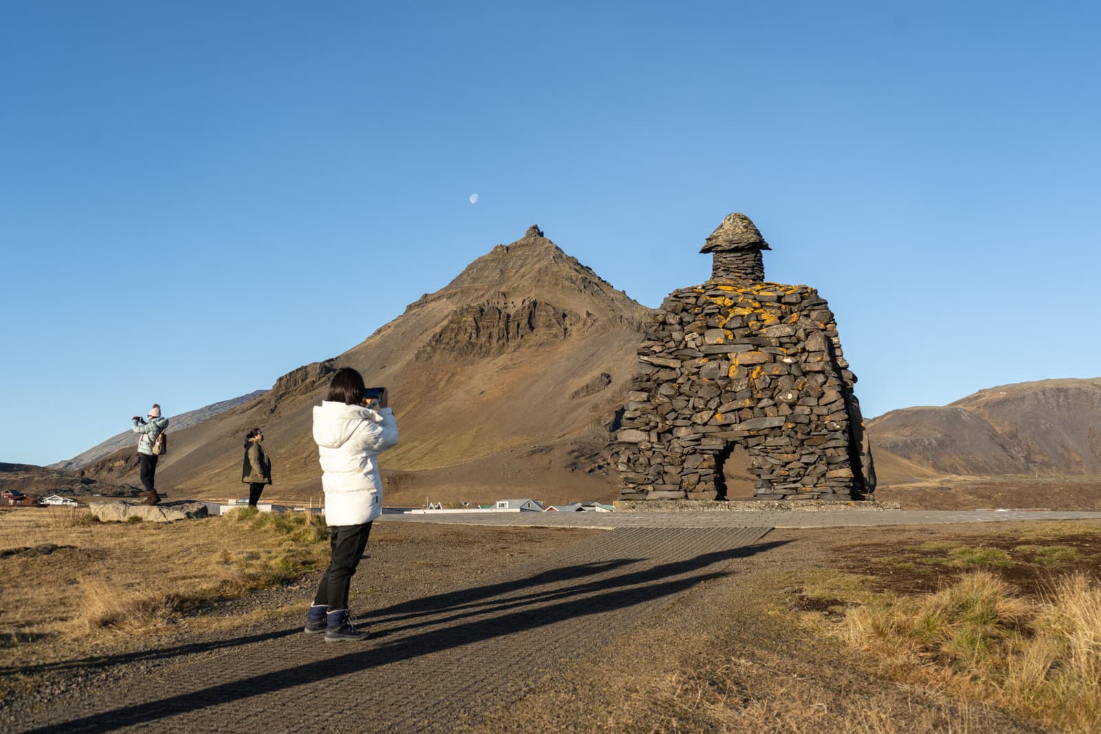 The Bárður Snæfellsás stone sculpture near Arnarstapi with Stapafell rising behind it.