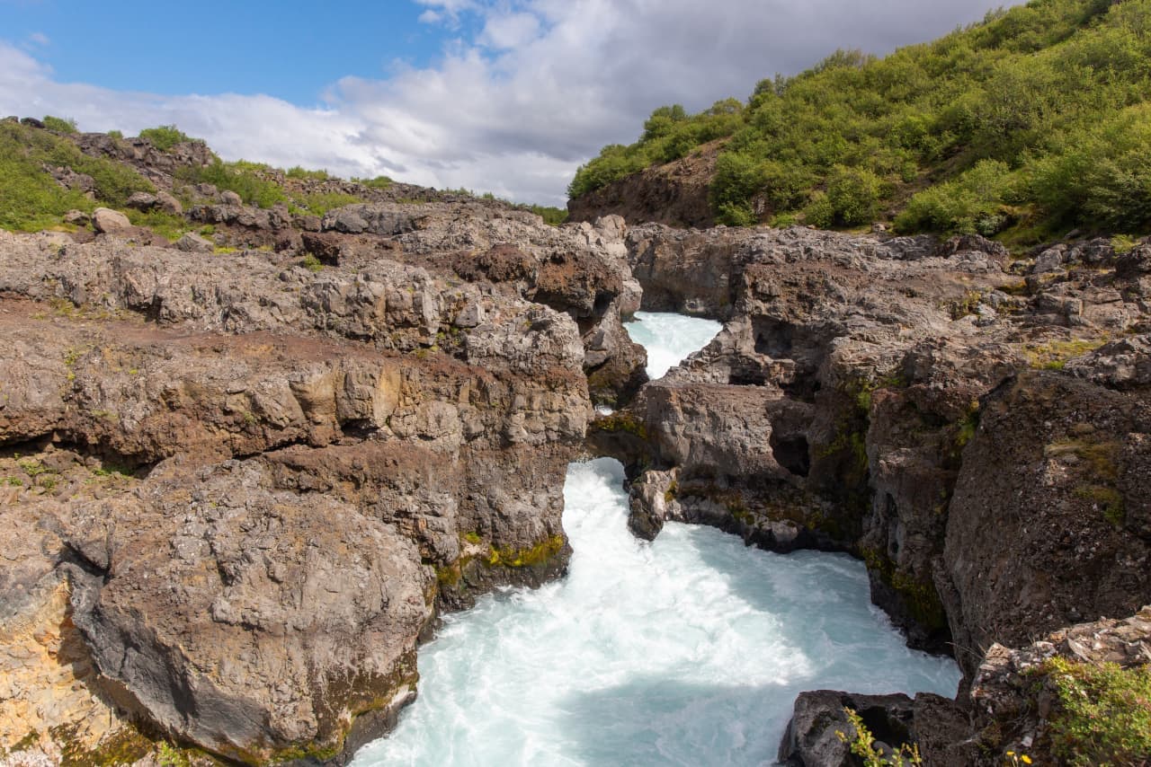 Barnafoss churning through a narrow lava-rock gorge in West Iceland.