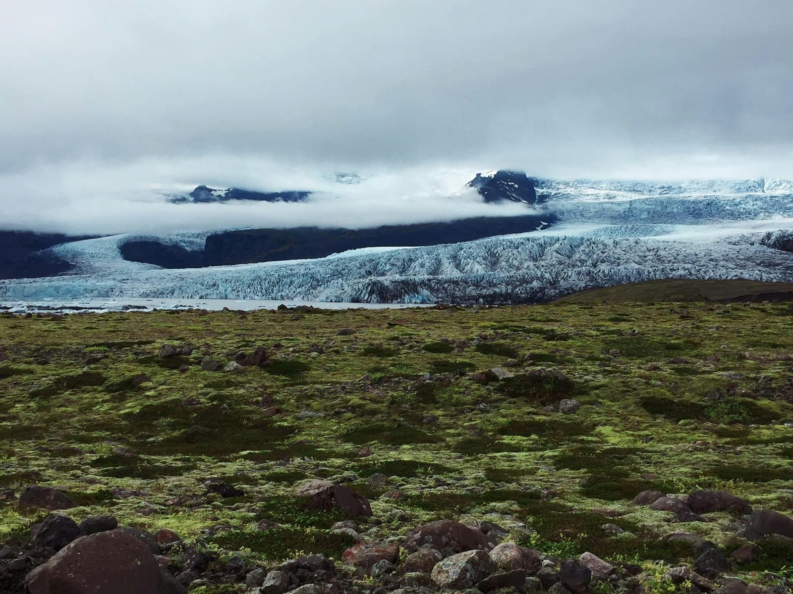 A glacier edge above mossy Breiðamerkursandur inside the Vatnajökull National Park landscape.