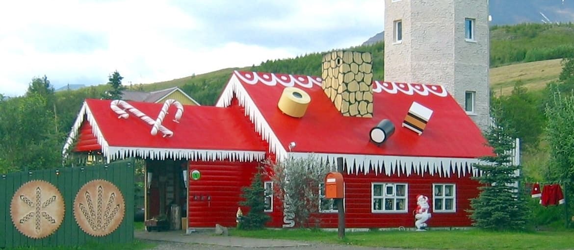 The red Akureyri Christmas House with candy-cane roof details and tower south of Akureyri.