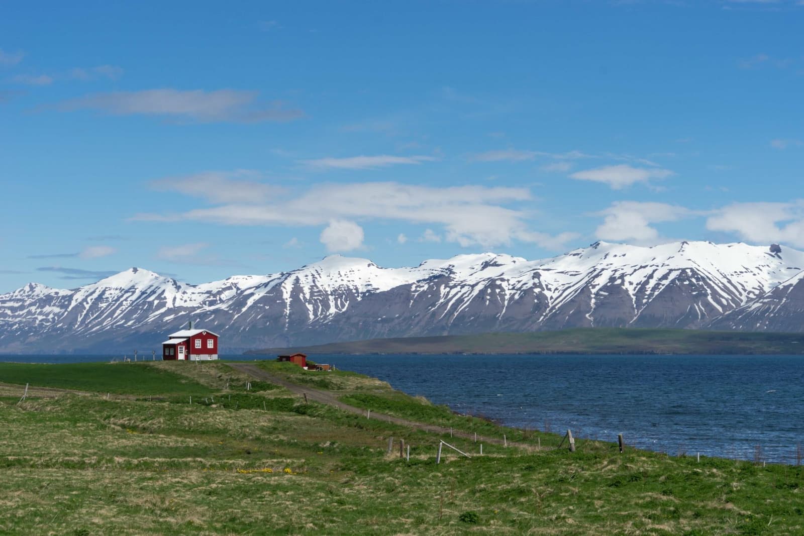 Dalvík town beside Eyjafjörður with North Iceland mountains rising behind the village.