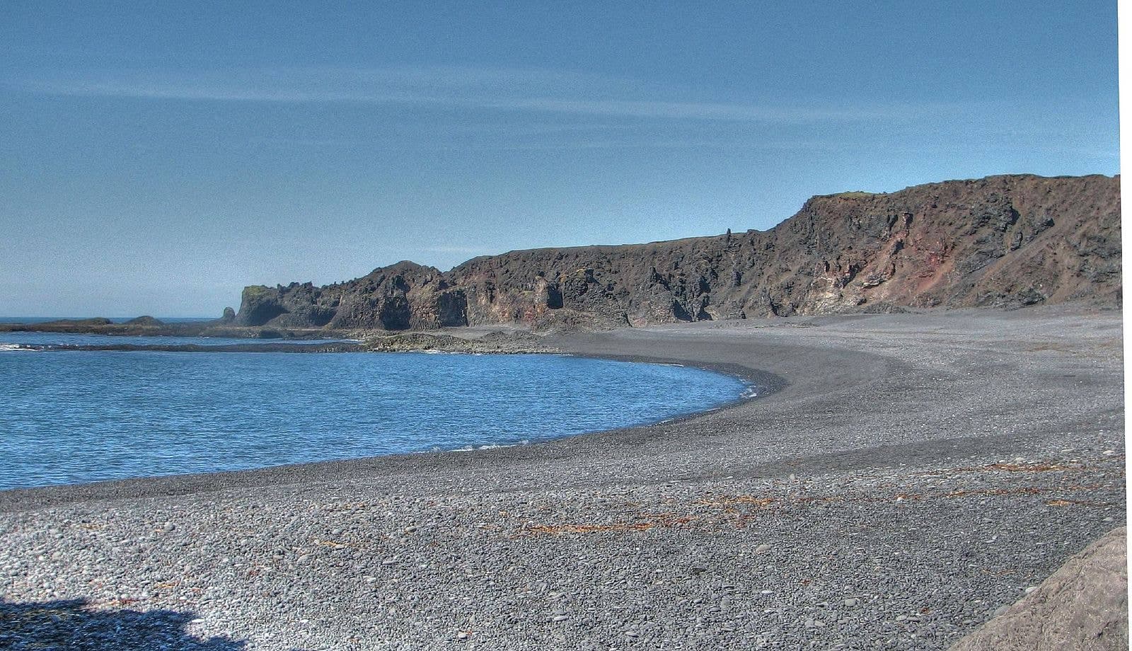 Djúpalónssandur black pebble beach below lava cliffs on the Snæfellsnes coast.
