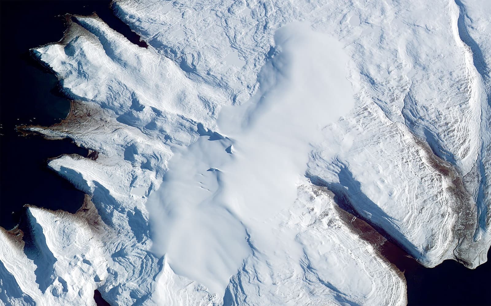 Satellite view of Drangajökull ice cap surrounded by fjords and snow-covered ridges in the Westfjords.