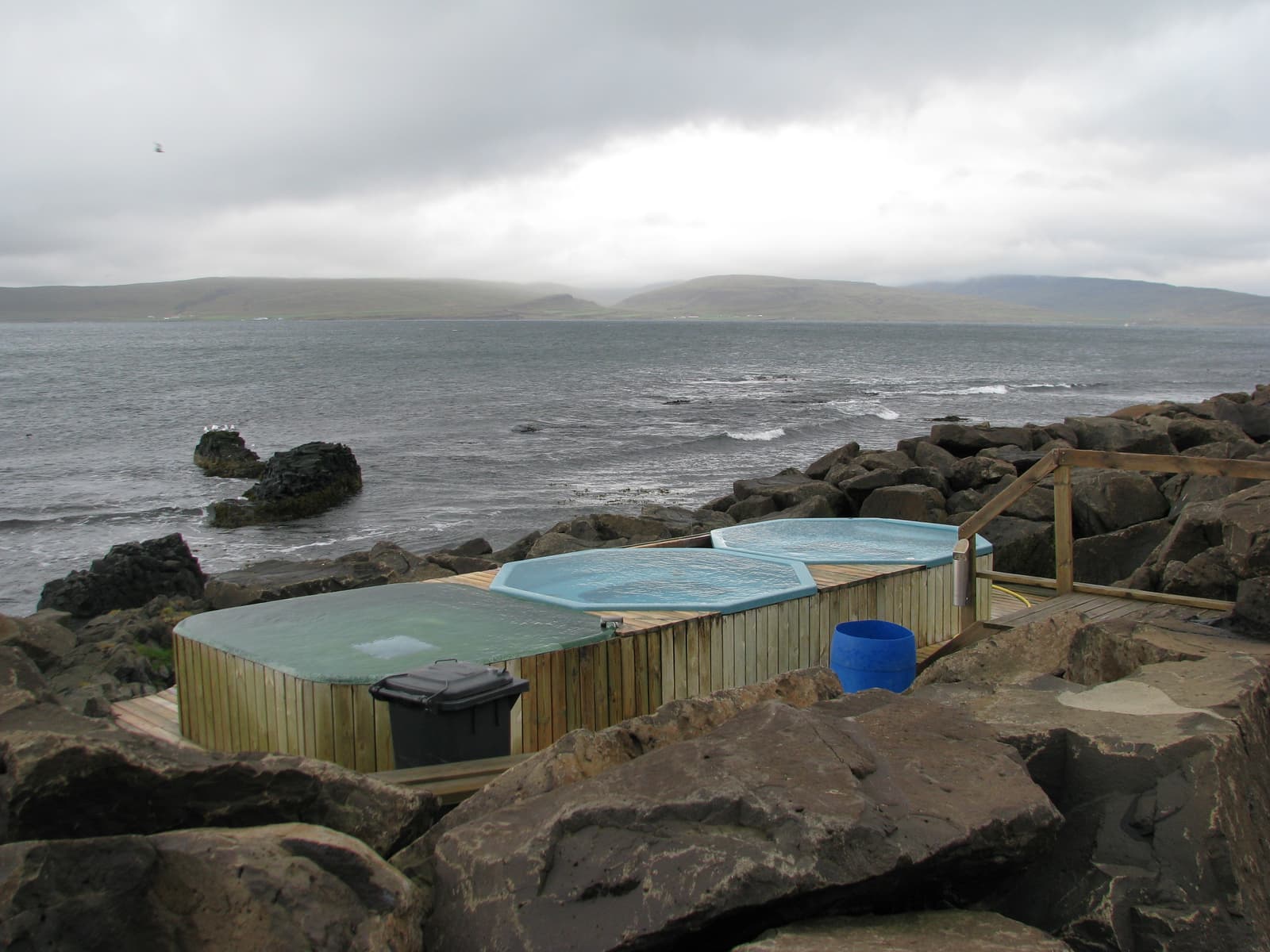 Three Drangsnes Hot Tubs beside Steingrímsfjörður on a cloudy Westfjords day.
