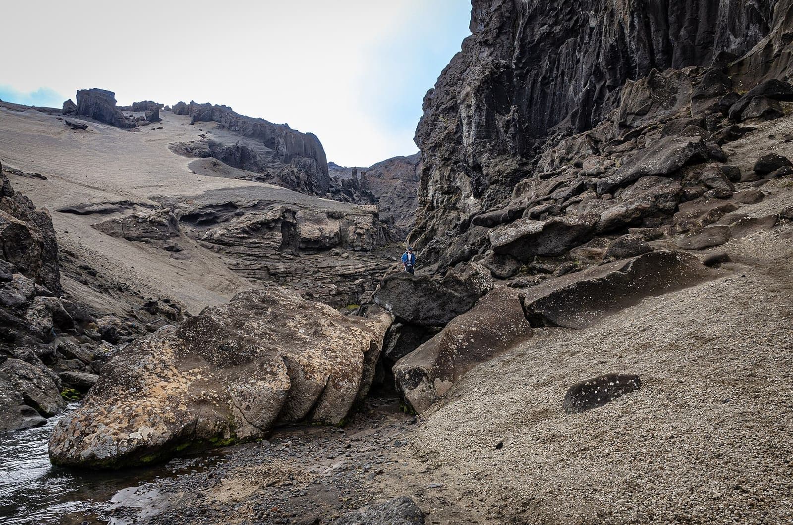 Dark volcanic walls and boulders inside Drekagil gorge near Dreki and Askja in the Icelandic Highlands.
