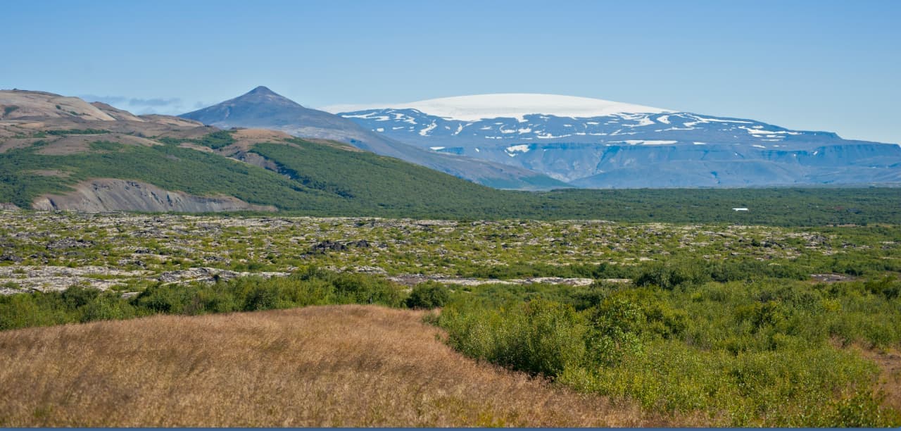 Eiríksjökull rising above Hallmundarhraun with a broad white glacier cap in West Iceland.
