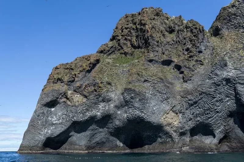 Elephant Rock's basalt cliff profile rising from the sea on Heimaey in the Westman Islands.