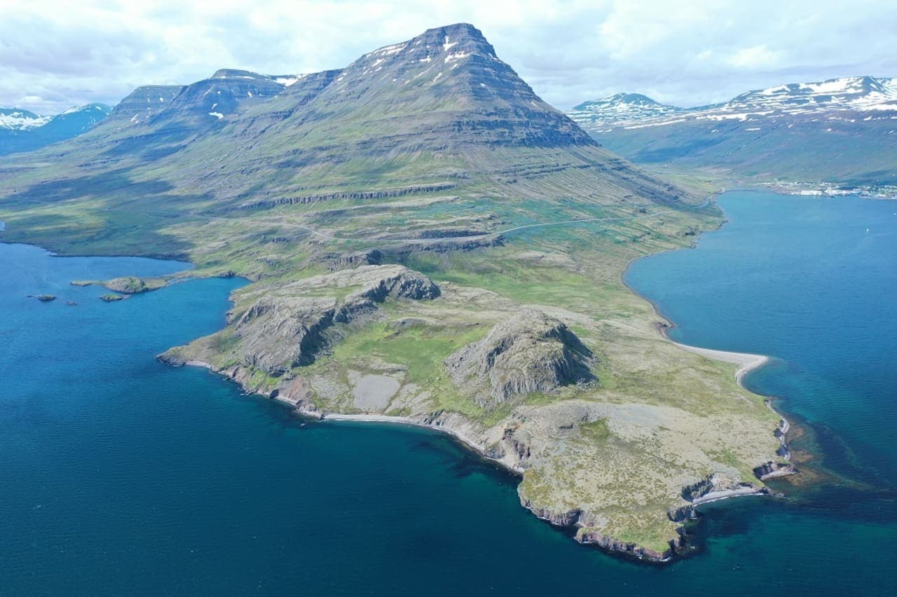 Aerial view of Eskifjörður fjord, Hólmatindur mountain, and the Eastfjords shoreline.
