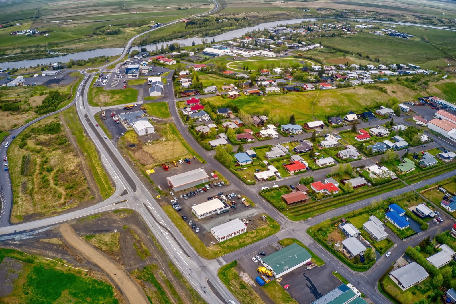 Aerial view of Hella, surrounding farmland, Ytri-Rangá, and roads in South Iceland.
