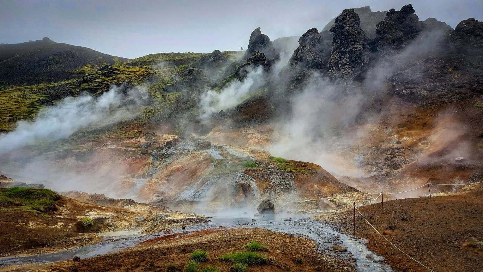 Steam rising from rocky geothermal ground in the Hengill area near Hveragerði.