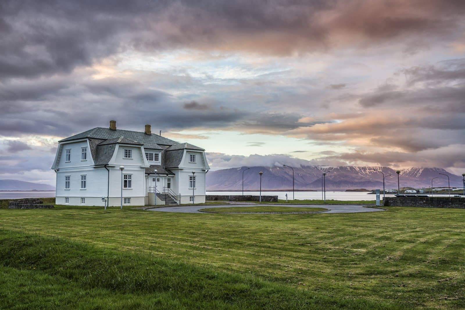Höfði house beside the Reykjavík waterfront with mountains across the bay