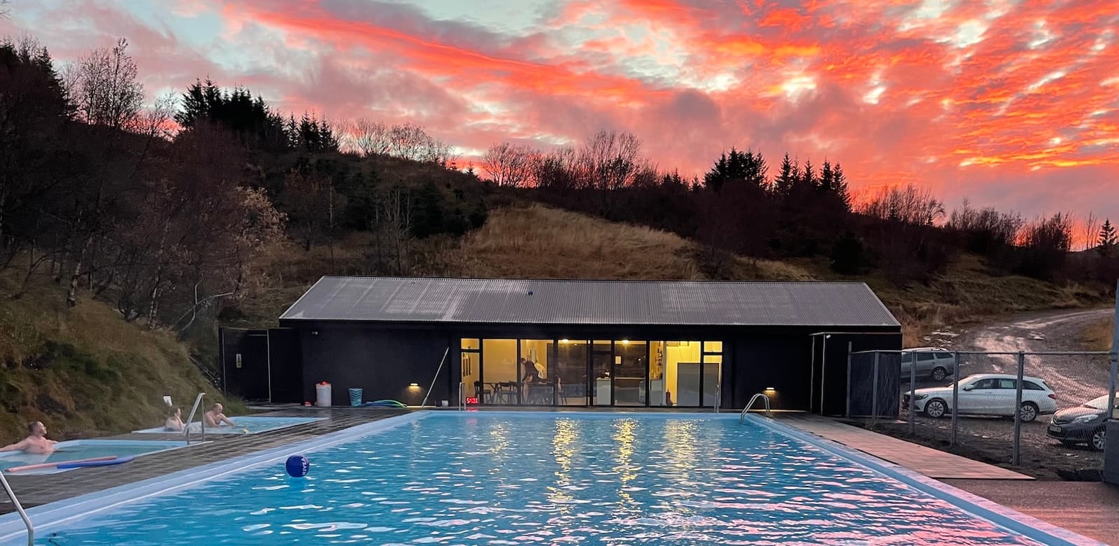 Hreppslaug Pool and its service building below a rural hillside in West Iceland.