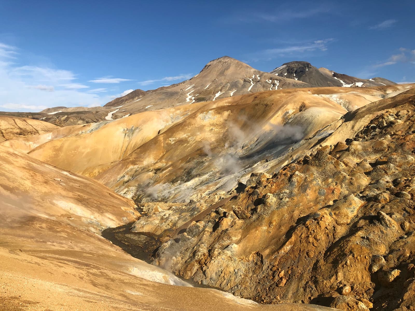 Steam rising from the colorful Hveradalir geothermal slopes in the Kerlingarfjöll mountains.