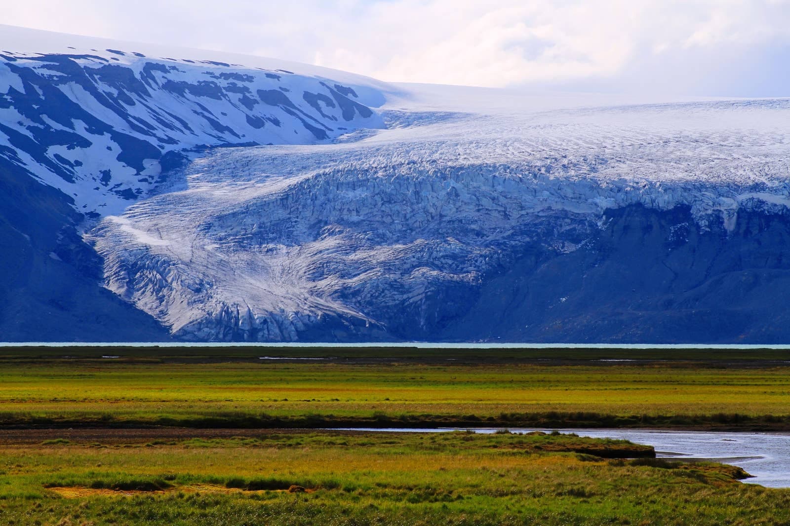 Langjökull glacier edge above dark highland ground in west Iceland.