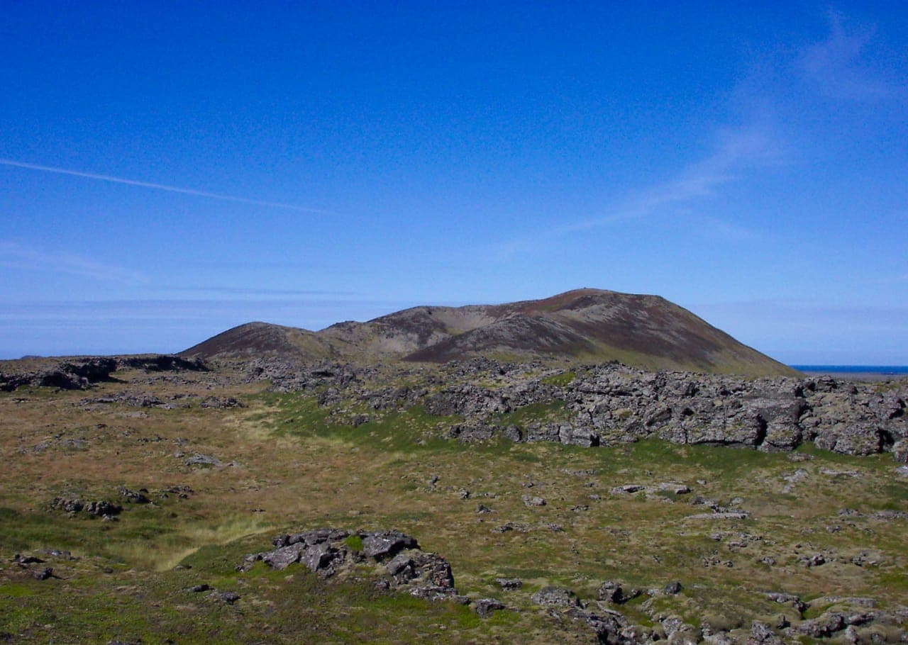 Saxhóll crater rising beyond lava fields on the Snæfellsnes Peninsula.