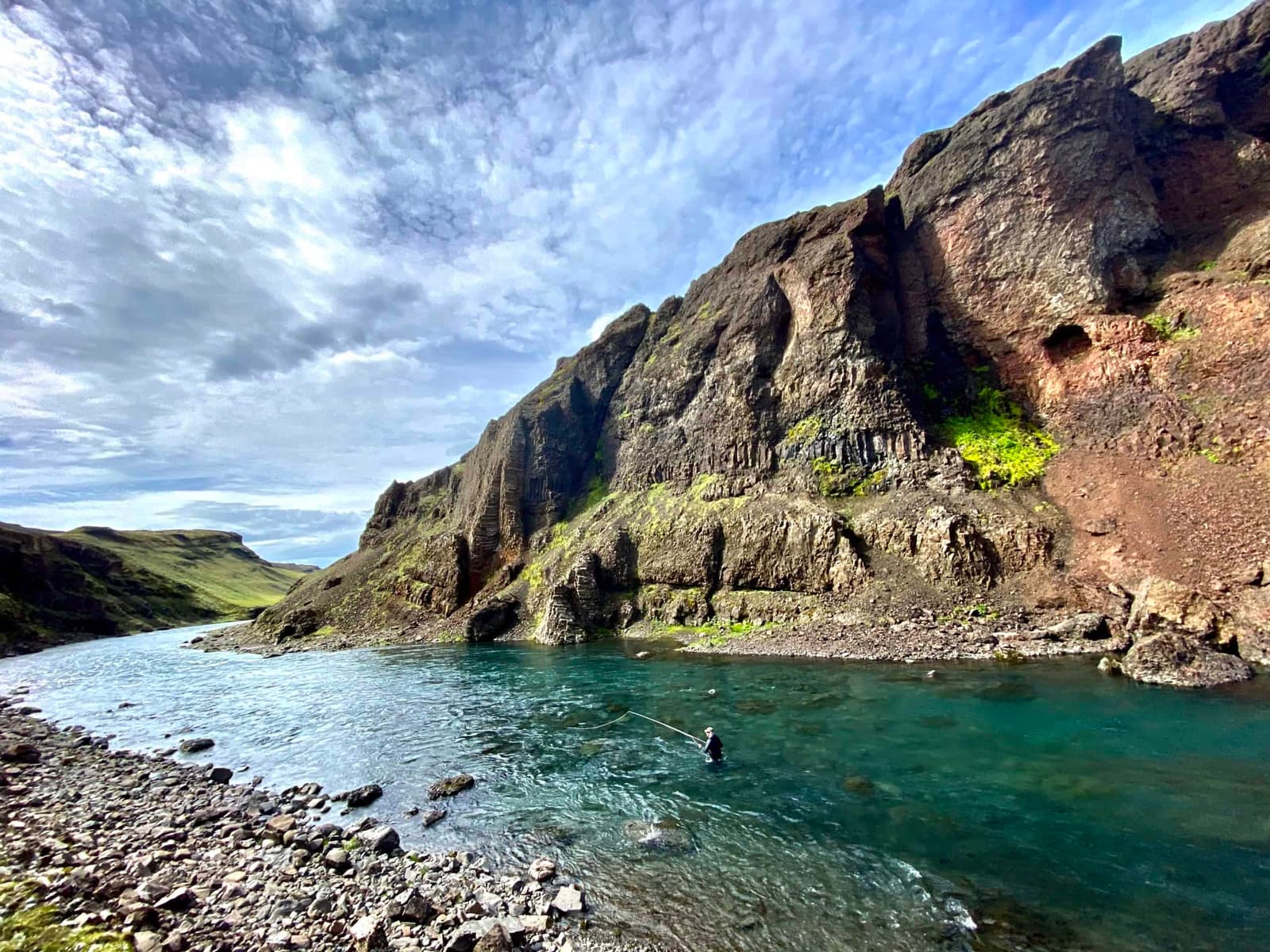 Steep rock walls and clear water in the Stóra-Laxá canyon in South Iceland.