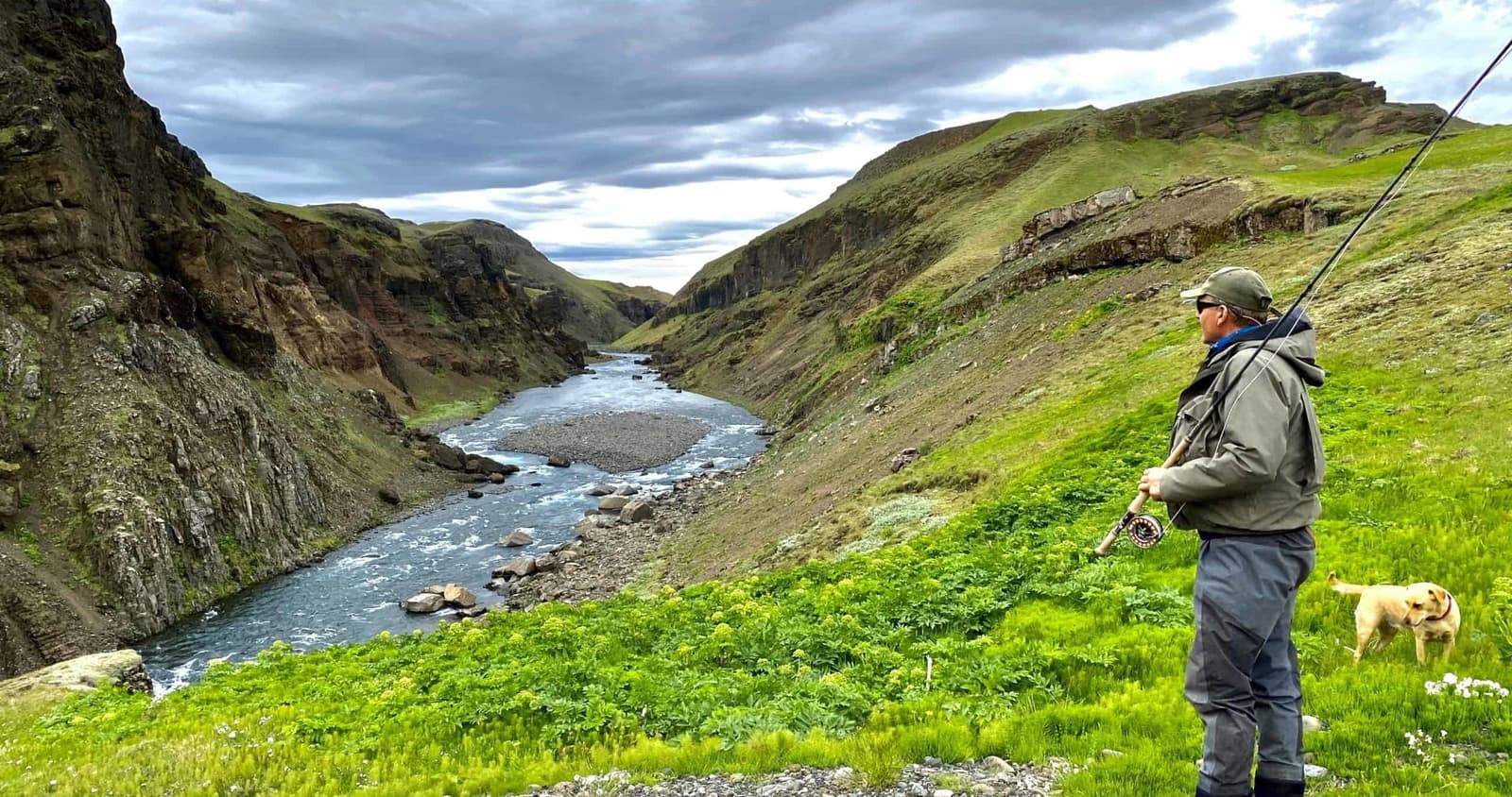 Angler overlooking the Stóra-Laxá river as it runs through a narrow green canyon in South Iceland.