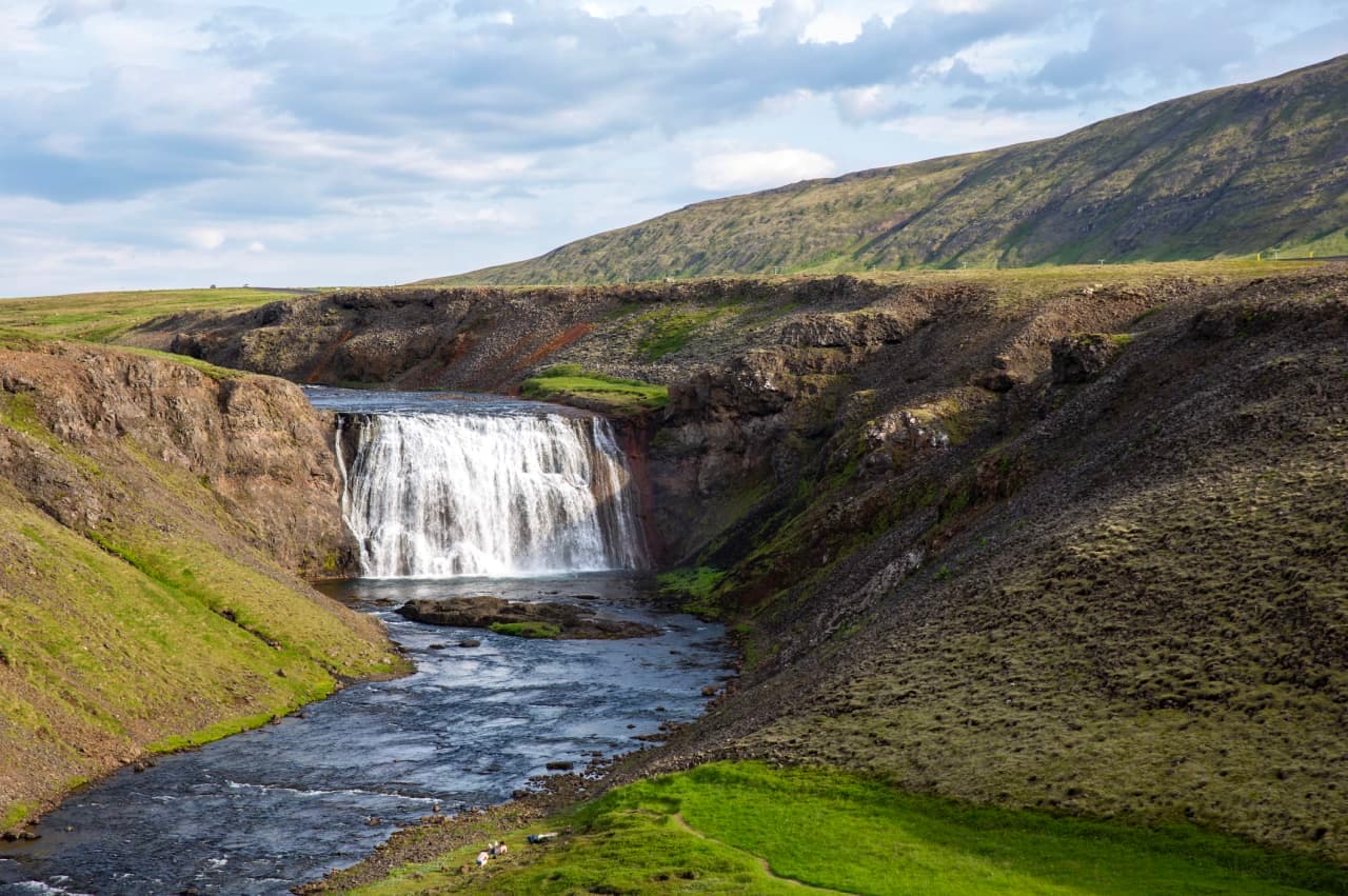Þórufoss waterfall dropping into a shallow green canyon on the Laxá í Kjós.