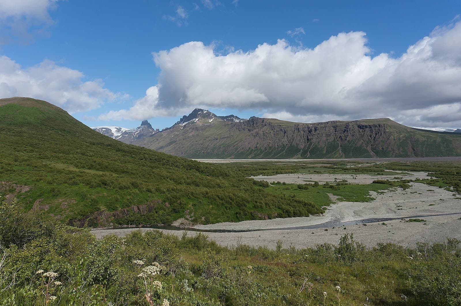 View from Vestragil across Morsárdalur, with green Skaftafell slopes, braided riverbeds, and mountain ridges.