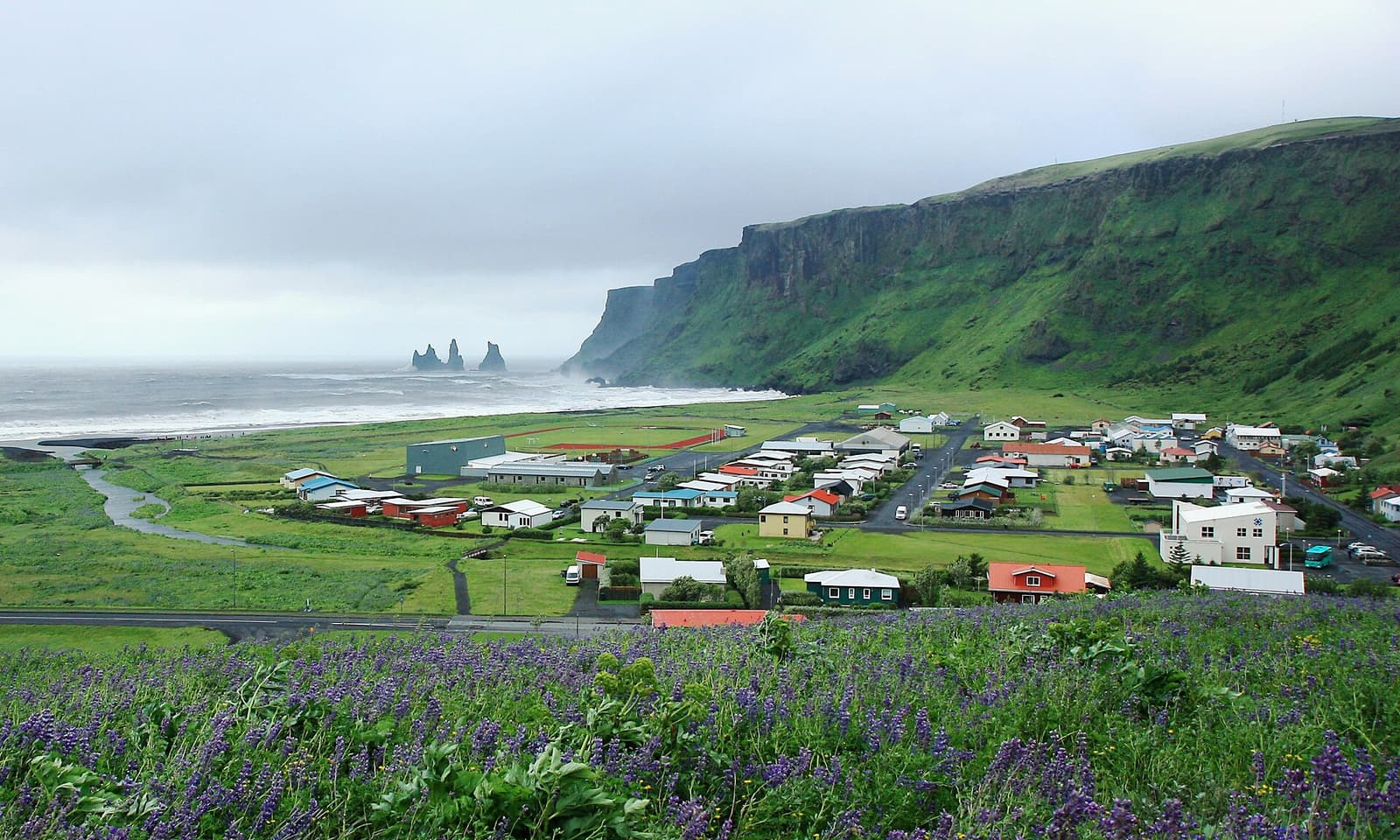 Vík village below the cliffs and black-sand coast on the South Coast of Iceland