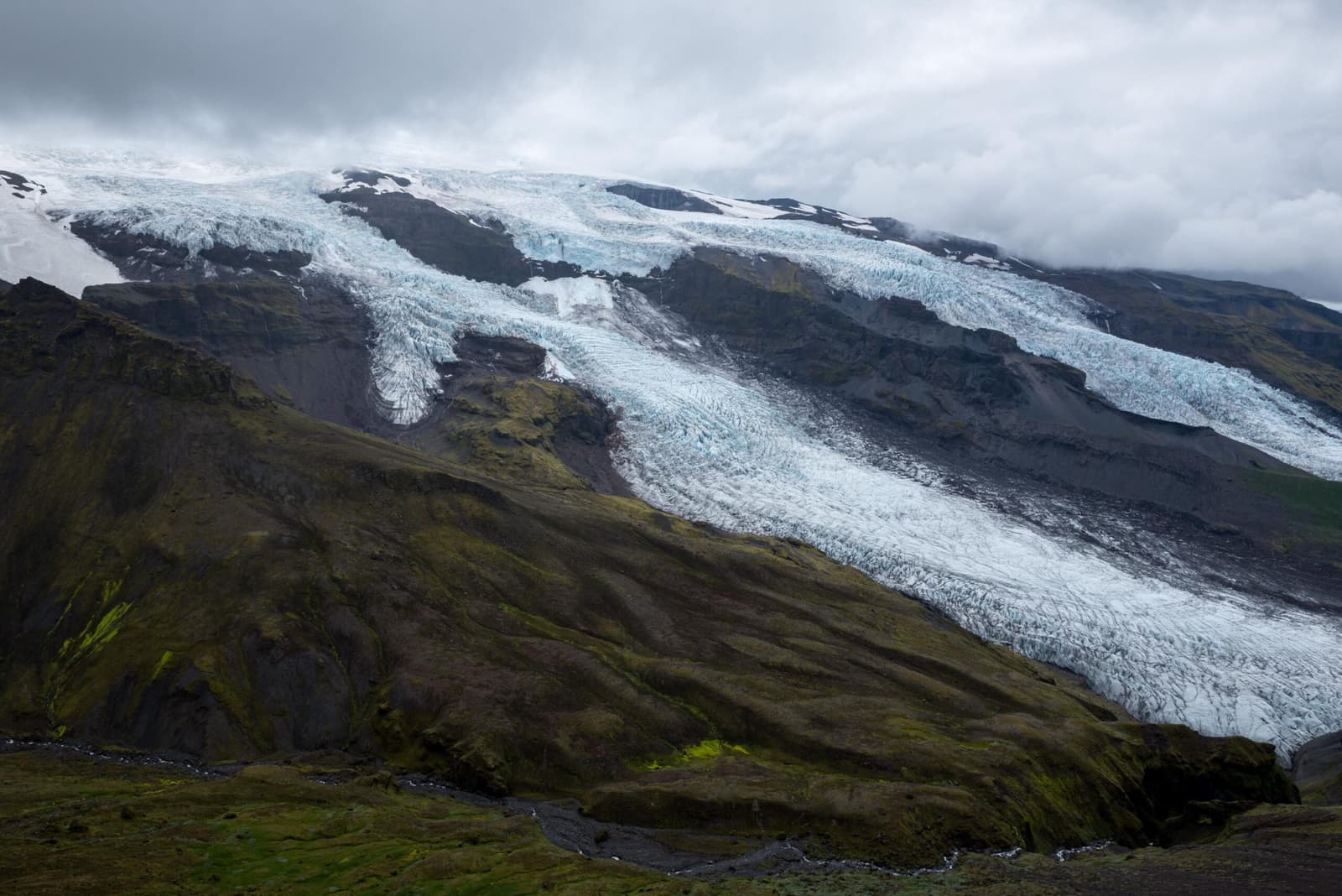Virkisjökull and Falljökull descending between dark ridges near Skaftafell.