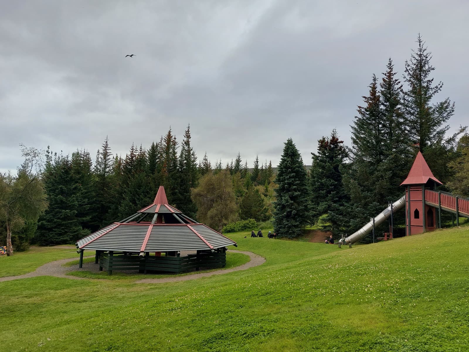 Shelters, paths, trees, and a slide in the Kjarnaskógur recreation forest near Akureyri.