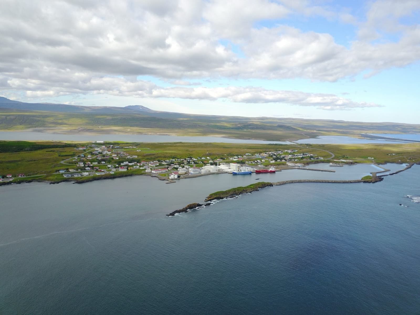 Aerial view of Vopnafjörður town on Kolbeinstangi with the broad fjord opening around it.