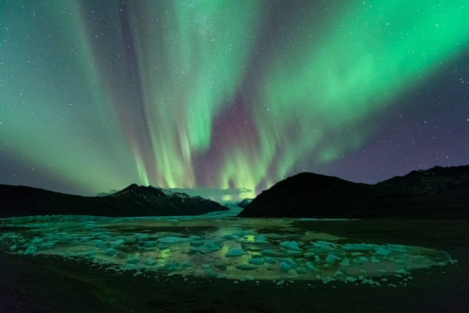 Northern lights over a glacier lagoon in South Iceland.