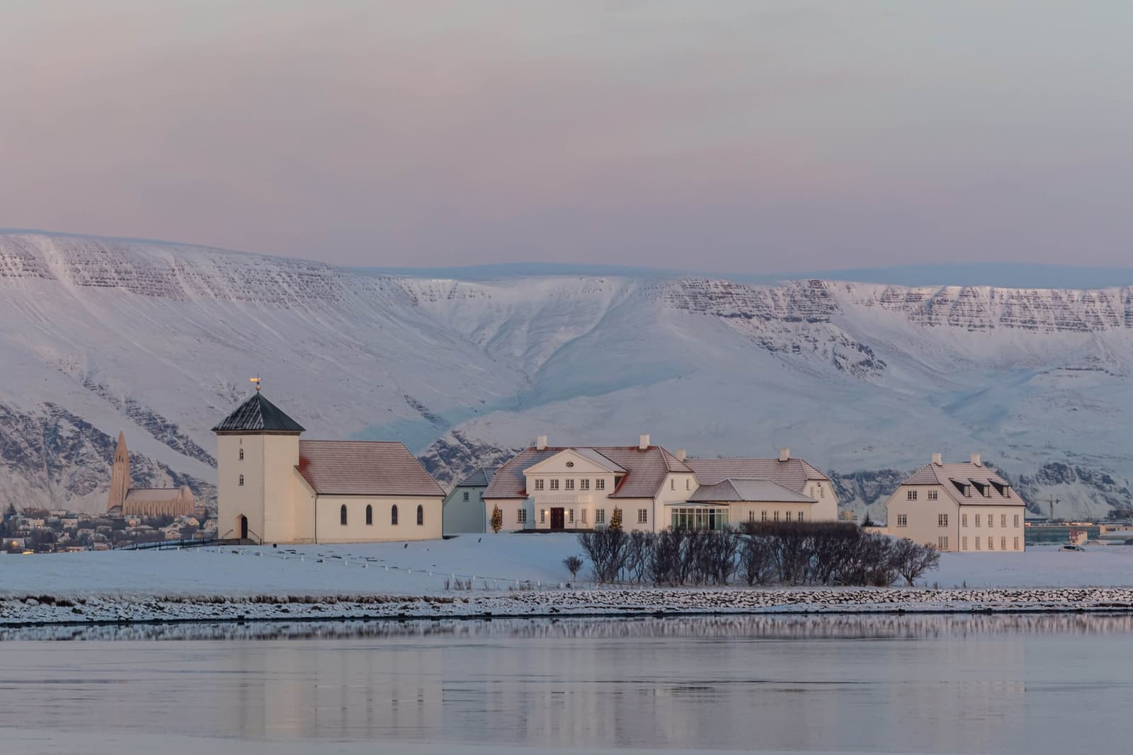 Bessastaðir presidential residence and church on Álftanes with mountains across the water.