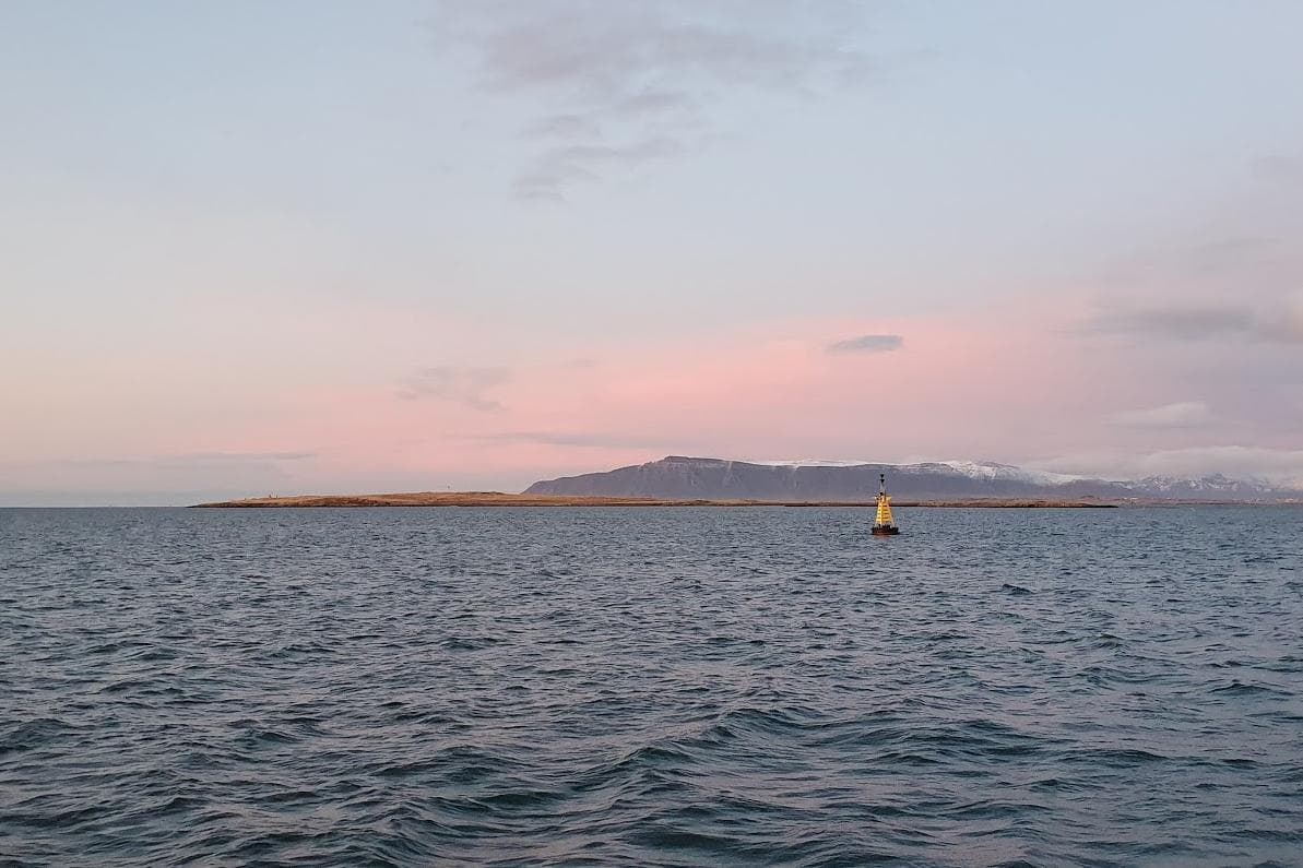 Engey island across Faxaflói water with Mount Esja behind it near Reykjavík