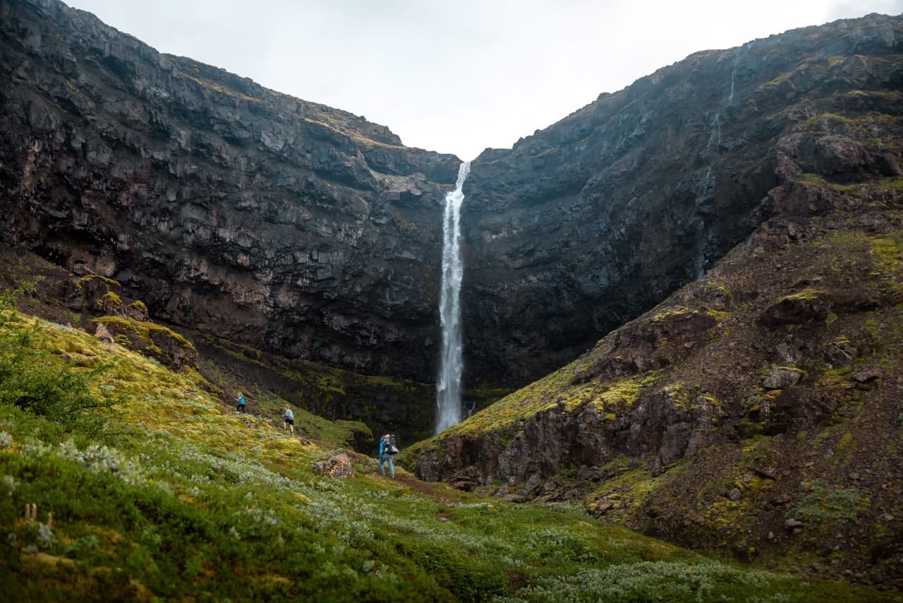 Flögufoss dropping into its narrow gorge below dark Eastfjords slopes in Breiðdalur.