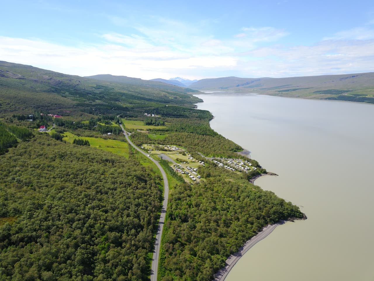 Aerial view of Hallormsstaðaskógur forest, Lake Lagarfljót, Route 931, and camping areas in East Iceland.