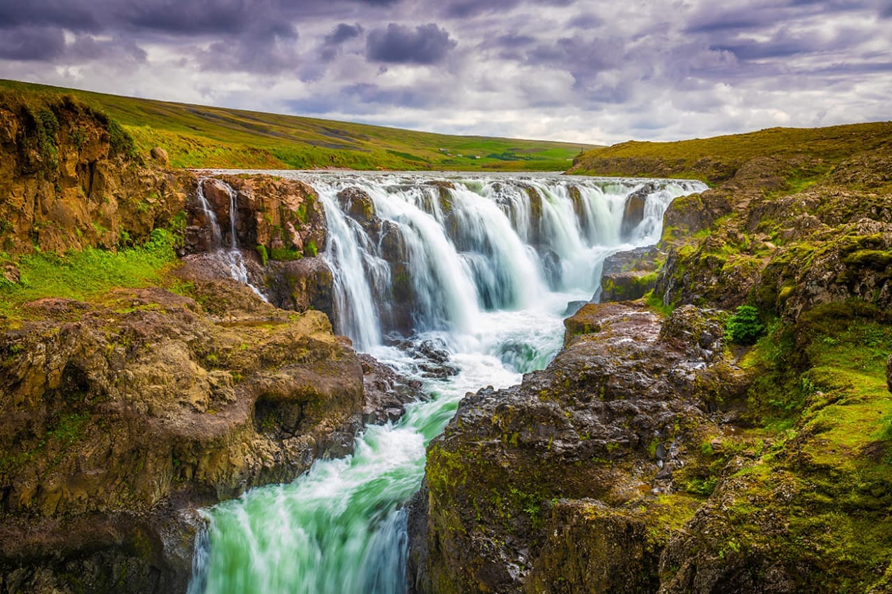 Kolufossar waterfalls dropping through the rocky Kolugljúfur canyon in North Iceland.
