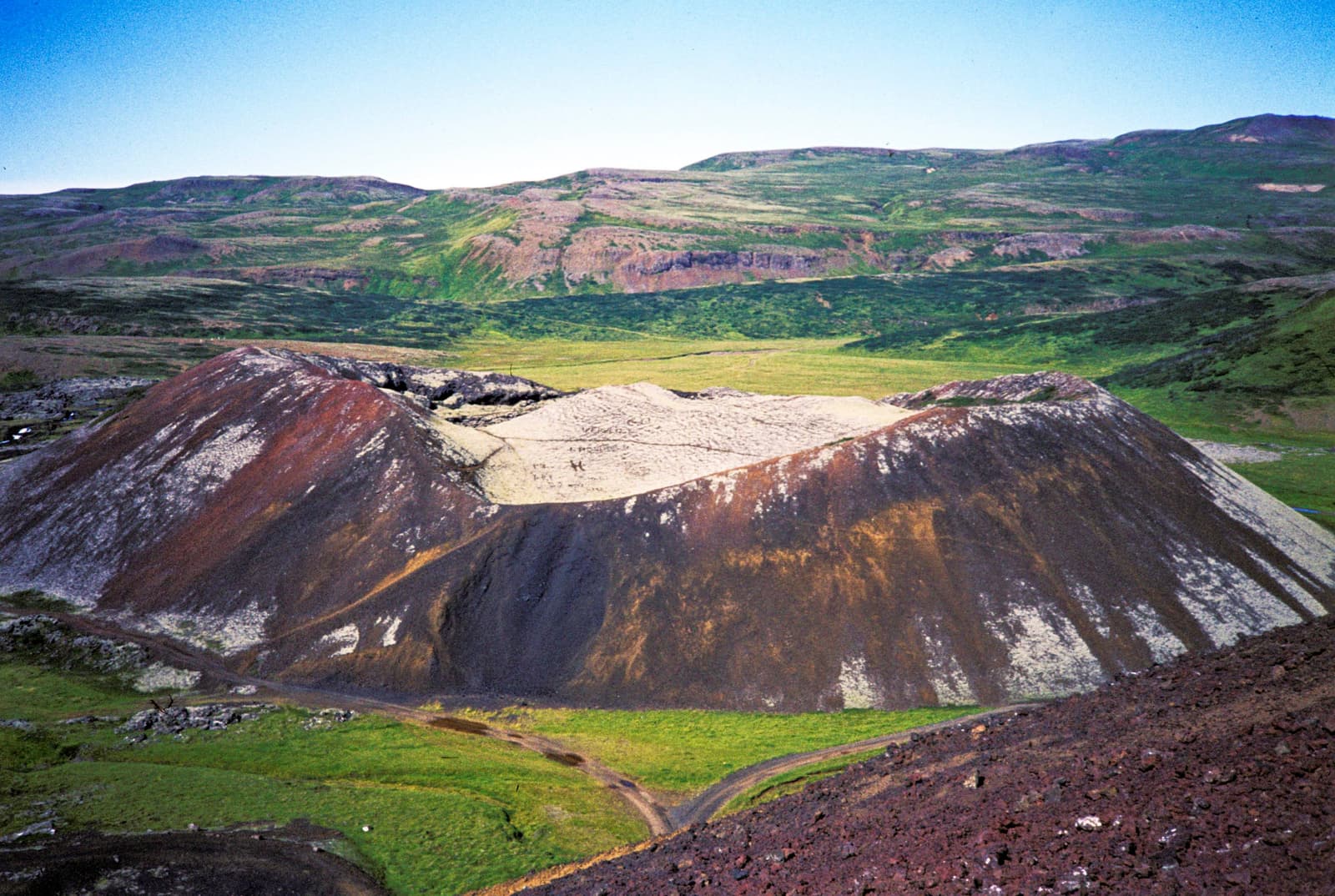 Colorful volcanic craters and pale slopes in the Ljósufjöll mountain range in West Iceland.