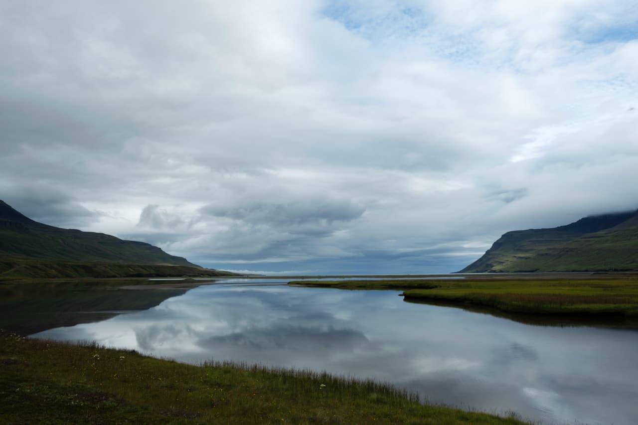 Quiet water and mountain slopes inside Loðmundarfjörður in the Eastfjords.