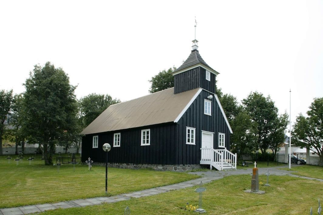 Munkaþverárkirkja timber church with dark cladding and white trim in Eyjafjörður.