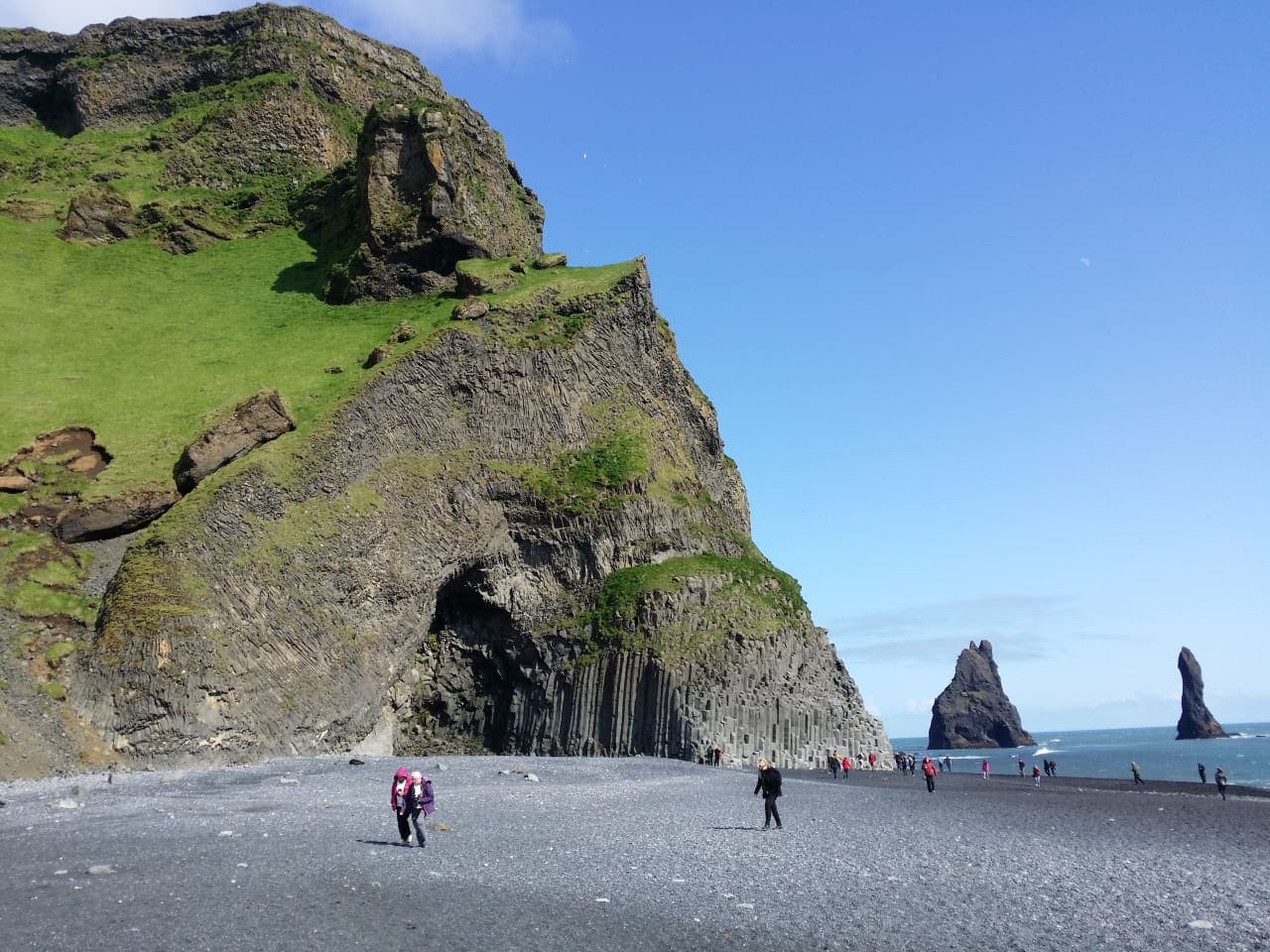 Reynisfjall cliffs above Reynisfjara black sand beach and Reynisdrangar sea stacks