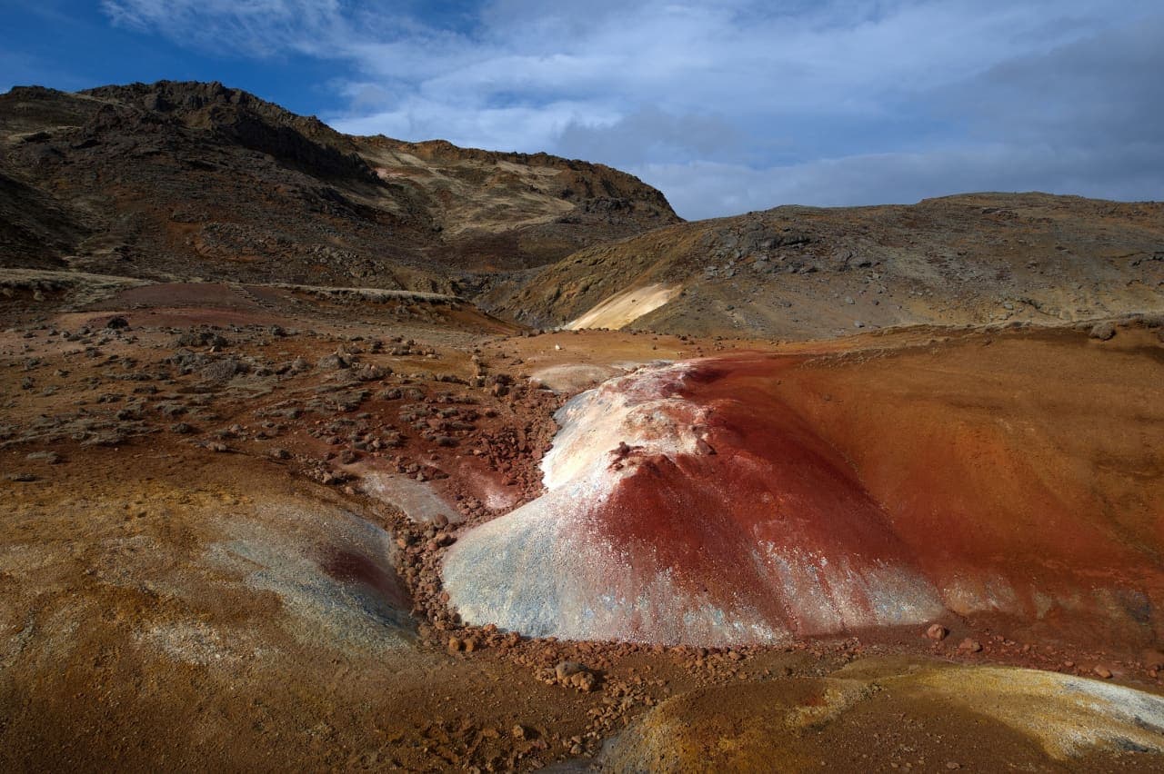 Colored mineral slopes and bare geothermal ground at Seltún on the Reykjanes Peninsula.