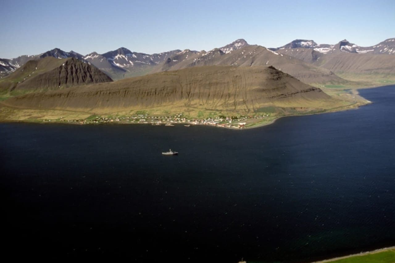 Þingeyri village on the shore of Dýrafjörður below the Westfjords Alps.